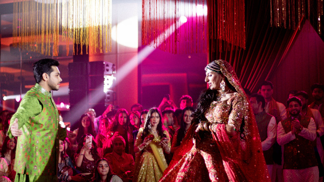 Indian wedding in Dubai - bride in a red lehenga and groom in a green sherwani, by Olga Events